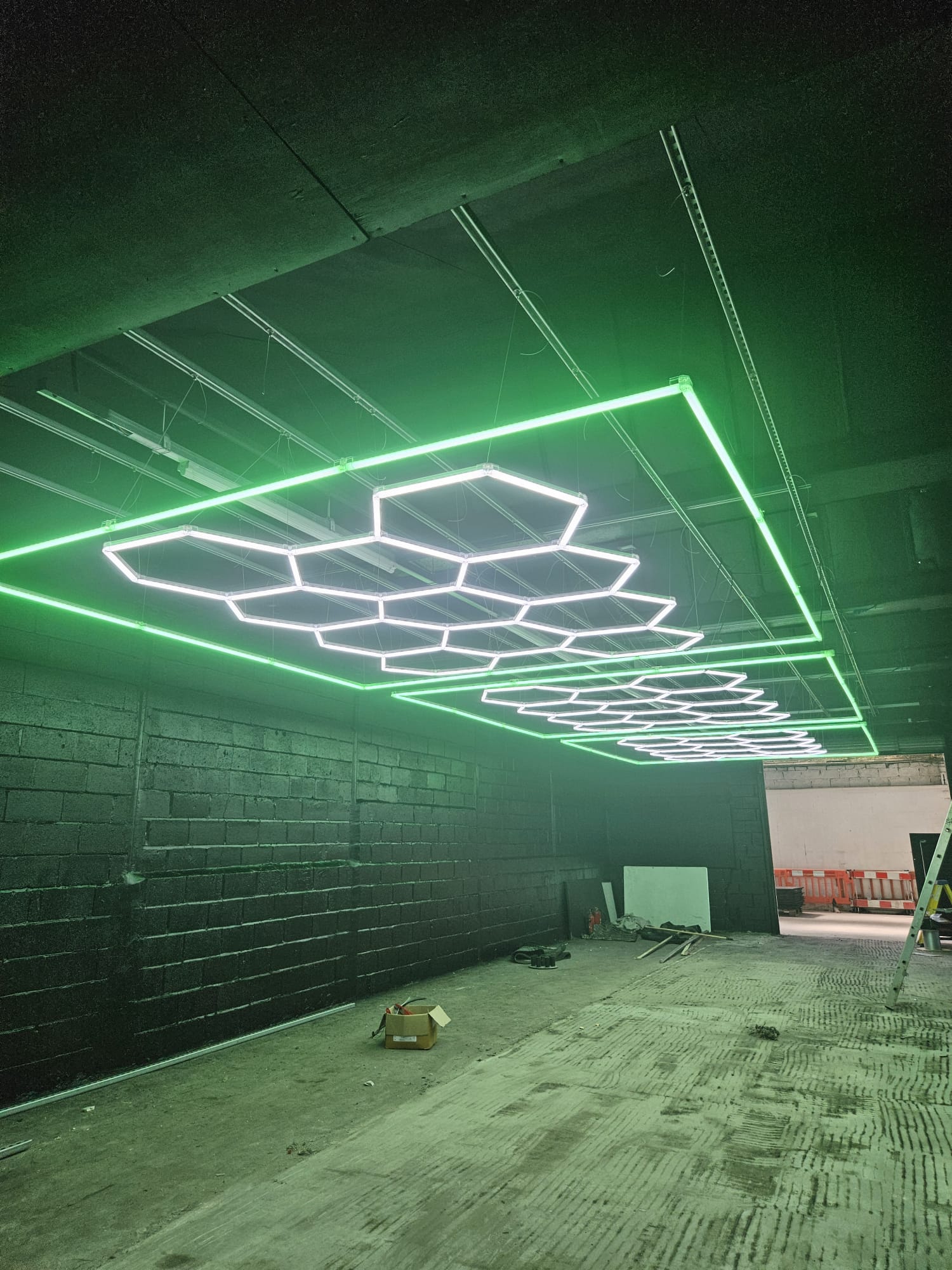 Completed suspended hexagon LED lighting installation at a gym in Darwen