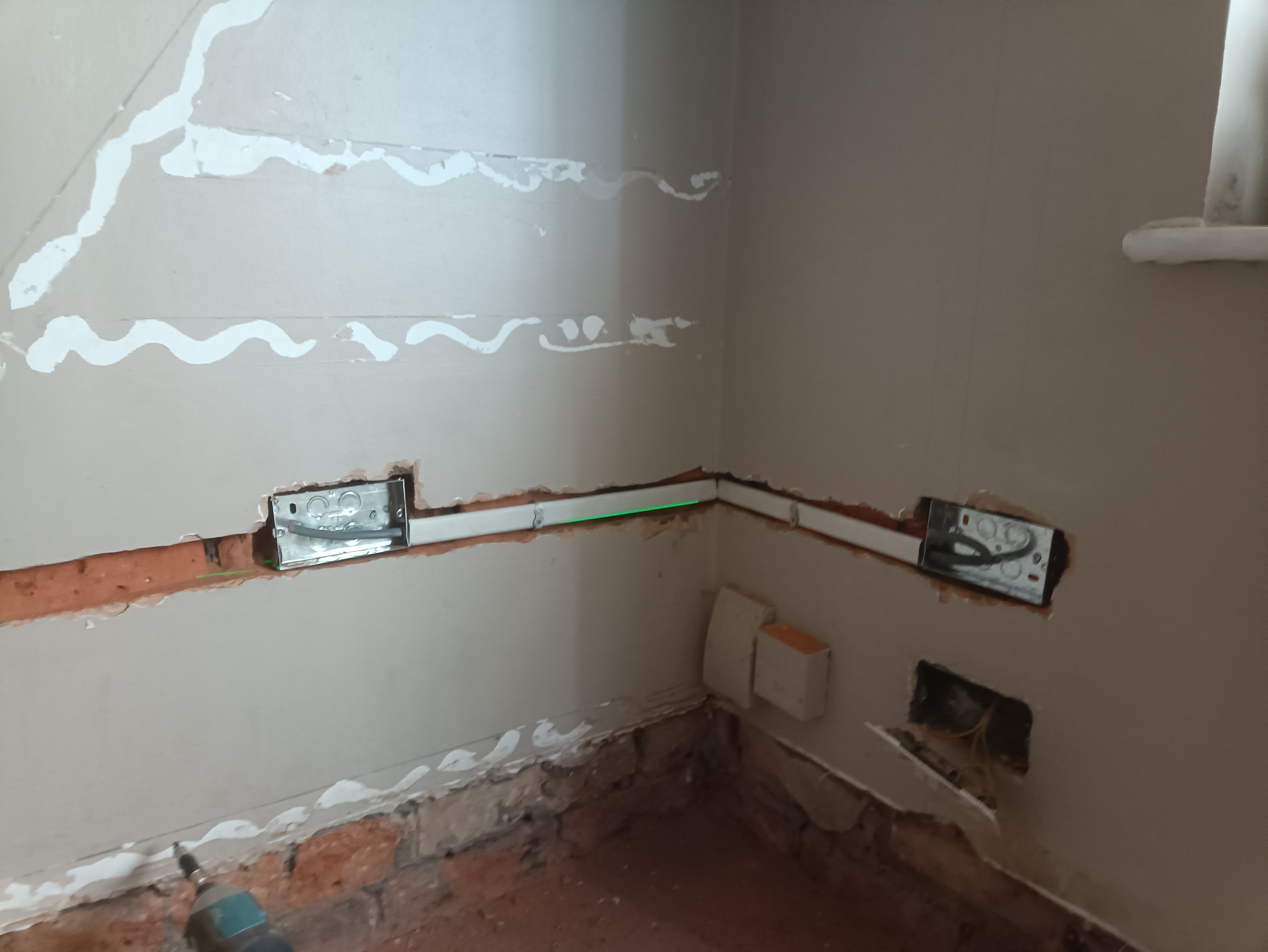 Electrical cable installed through oval conduit during first fix