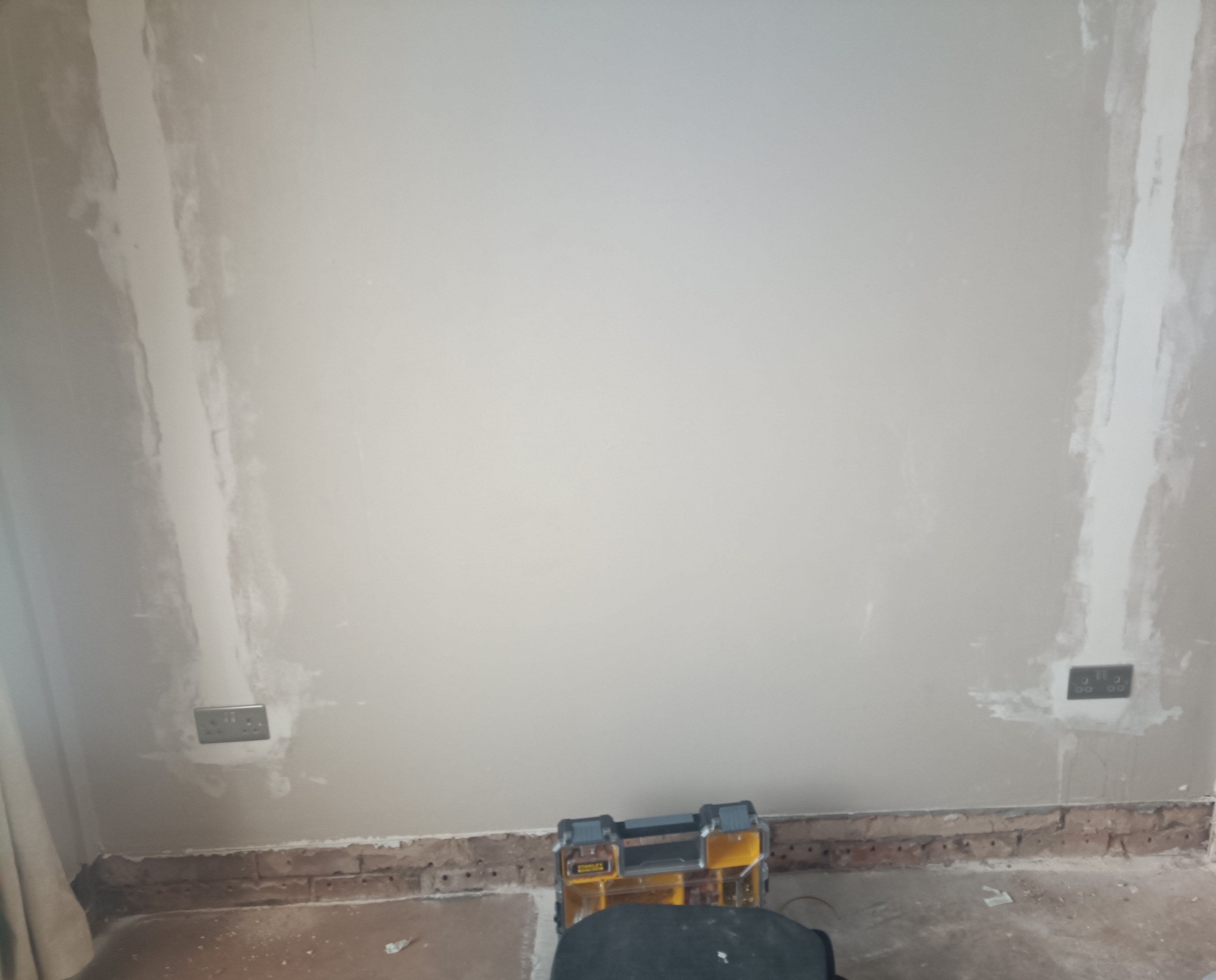 Finished brushed steel socket outlets following plastering and second fix